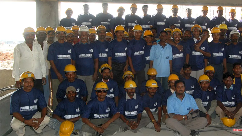 Large uniformed workforce with safety helmets at a plant site