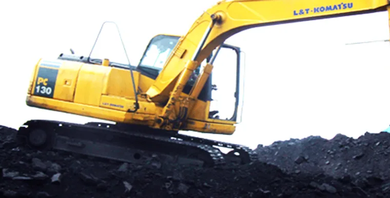 Excavator loading coal at a materials handling yard